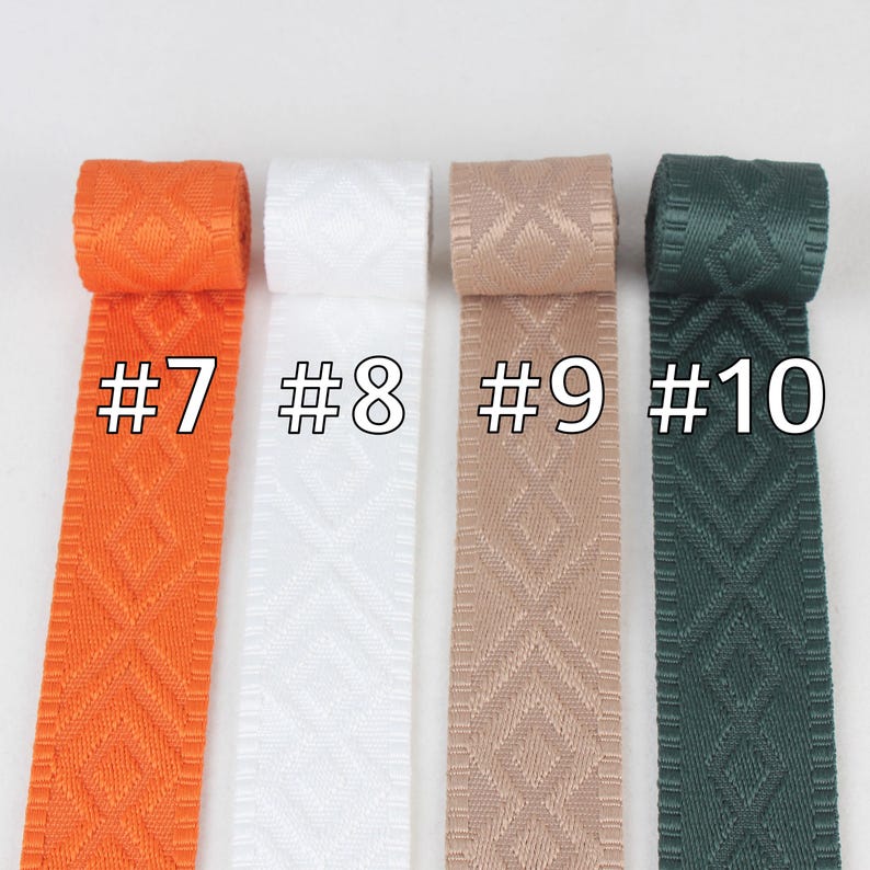 May include: Four rolls of woven ribbon in orange, white, beige, and green. The ribbon has a diamond pattern and is labeled #7, #8, #9, and #10.