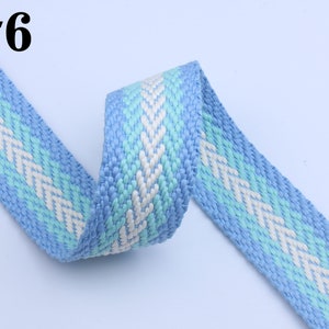 May include: A blue and white woven ribbon with a chevron pattern. #6