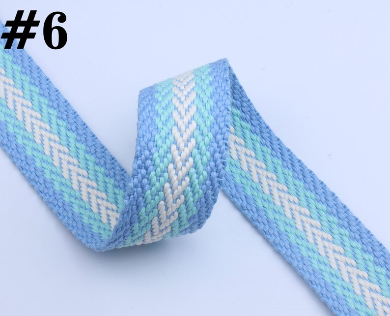 May include: A blue and white woven ribbon with a chevron pattern. #6