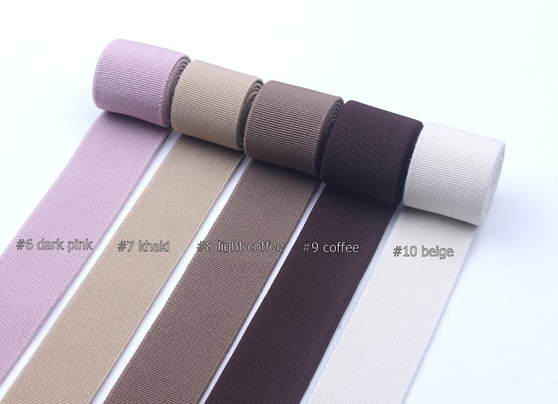 May include: Five spools of ribbon in different colors: dark pink, khaki, light coffee, coffee, and beige. The ribbon is labeled with numbers 6 through 10.