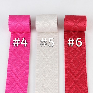 May include: Three rolls of patterned ribbon in pink, white, and red. The ribbon is labeled #4, #5, and #6.