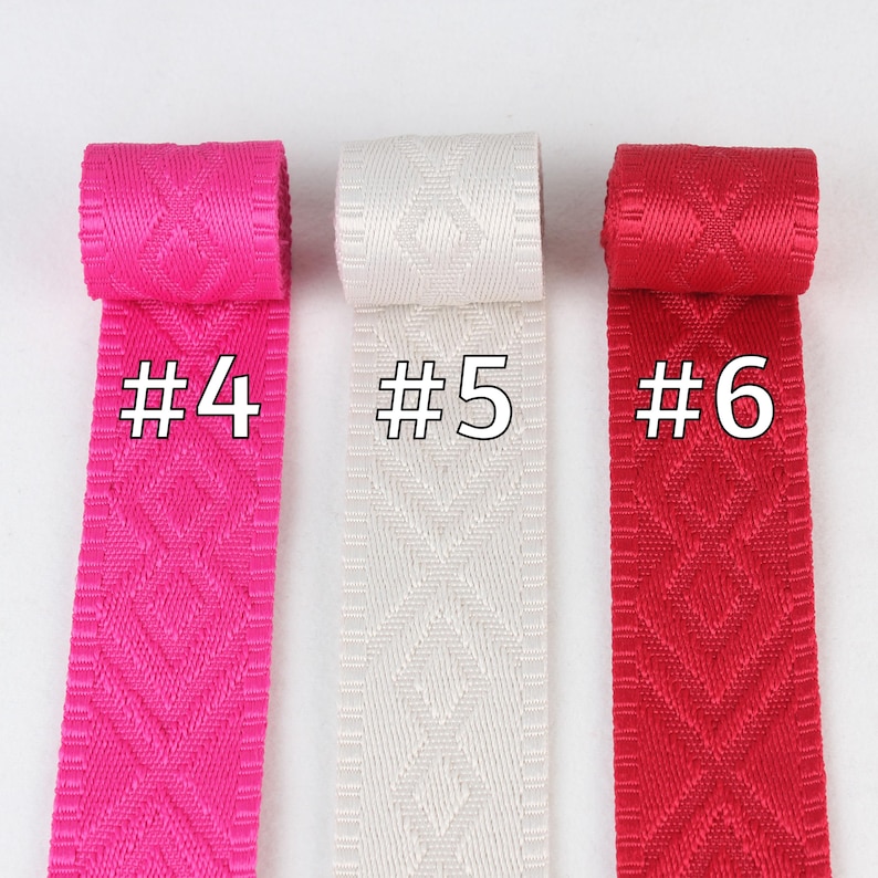 May include: Three rolls of patterned ribbon in pink, white, and red. The ribbon is labeled #4, #5, and #6.