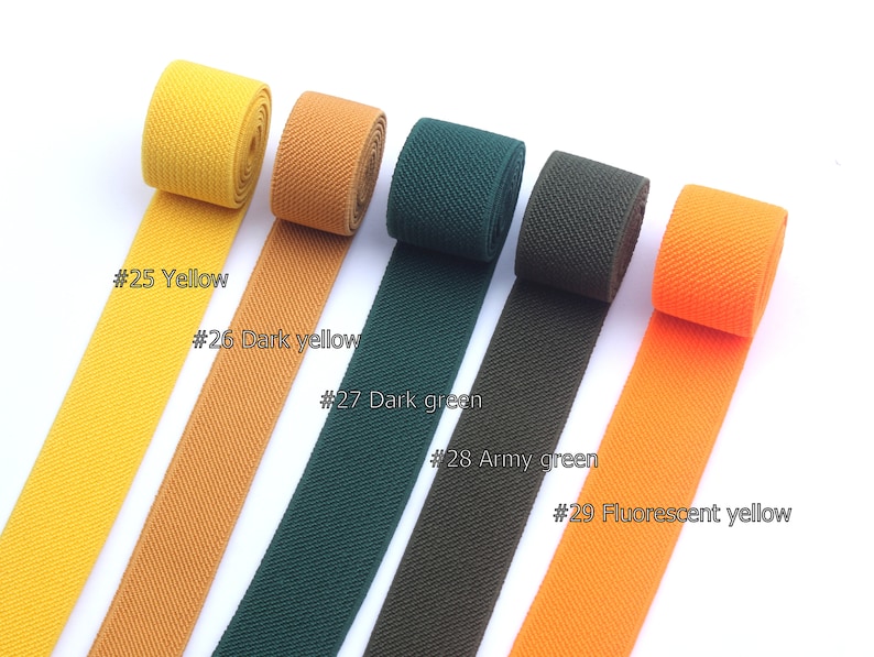 May include: Five different colors of woven elastic ribbon, including yellow, dark yellow, dark green, army green, and fluorescent yellow. Each ribbon is labeled with a number and color name.