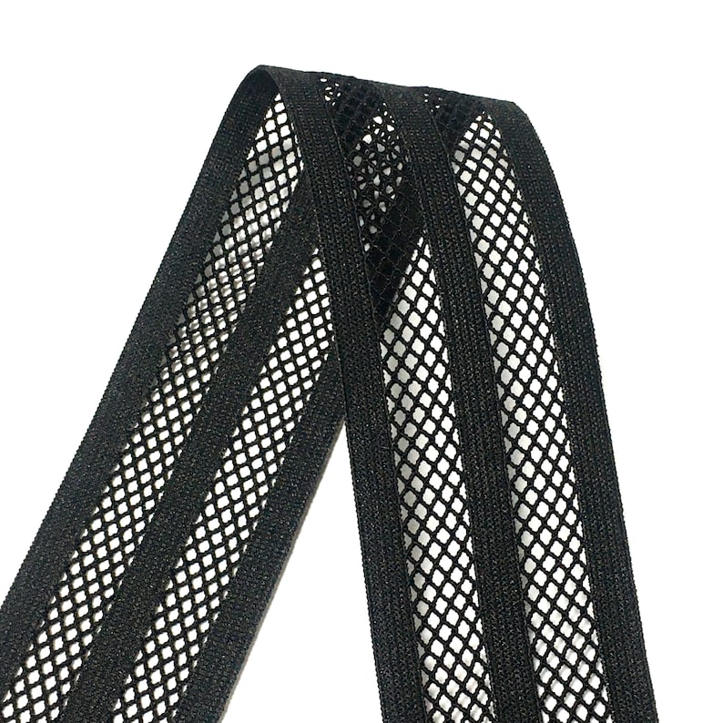 May include: Black elastic trim with a mesh design. The trim has three rows of mesh, creating a striped pattern.