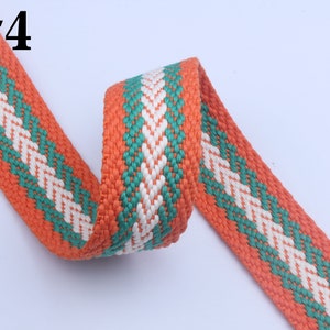 May include: Orange, green, and white woven cotton webbing with a diamond pattern. #4