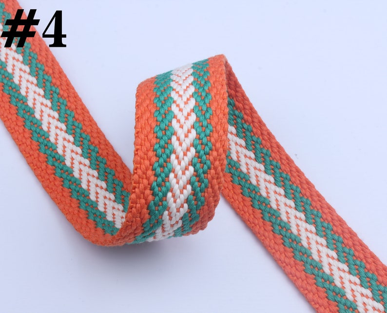 May include: Orange, green, and white woven cotton webbing with a diamond pattern. #4