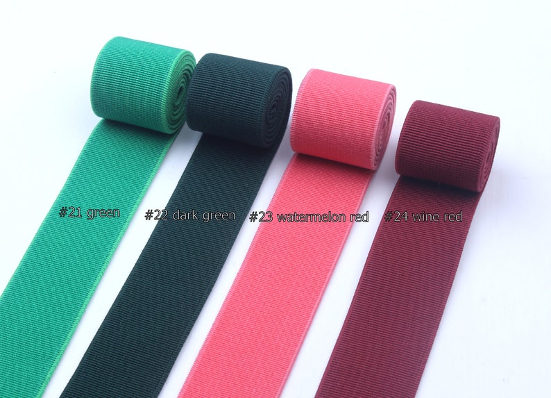 May include: Four rolls of elastic ribbon in different colors: green, dark green, watermelon red, and wine red. The ribbon is ribbed and has a slight sheen. The text on the image reads: #21 green, #22 dark green, #23 watermelon red, #24 wine red.