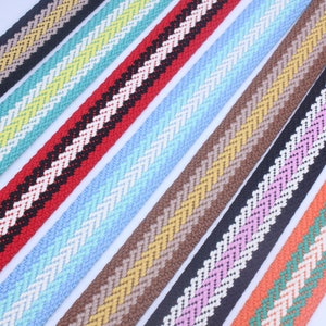 May include: Assortment of colorful striped woven ribbon with a chevron pattern. The ribbons are in various colors including red, blue, brown, pink, and orange.