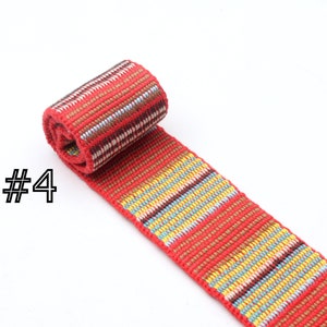 May include: Red, yellow, blue, and brown woven ribbon with a striped pattern. The ribbon is rolled up and labeled with the number "#4".