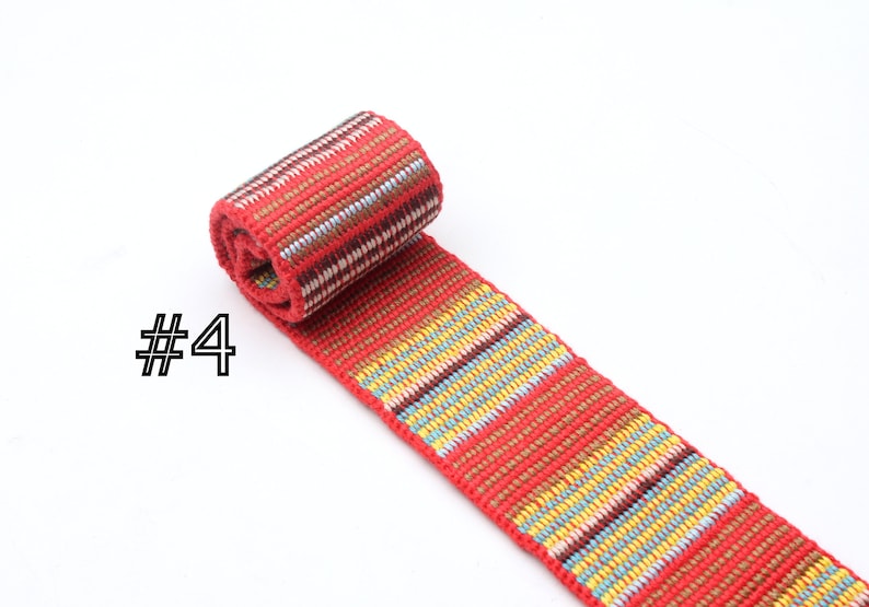May include: Red, yellow, blue, and brown woven ribbon with a striped pattern. The ribbon is rolled up and labeled with the number "#4".