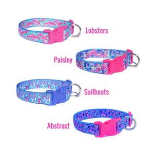 May include: Four different dog collars with various blue and pink patterns. The collars feature a pink, blue, or purple buckle and a silver D-ring. The patterns include lobsters, paisley, sailboats, and an abstract design. The collars are labeled "Lobsters", "Paisley", "Sailboats", and "Abstract".