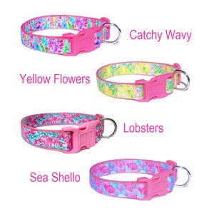 May include: Four different dog collars with pink buckles and various colorful patterns. The patterns include yellow flowers, pink and blue sea shells, pink and blue lobsters, and a pink and blue wavy pattern. The collars are labeled with the names of the patterns.