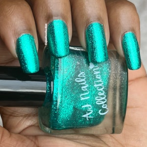 May include: A bottle of teal green nail polish with a sparkly finish. The bottle is labelled "Az Nails Collection".