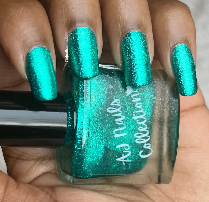 May include: A bottle of teal green nail polish with a sparkly finish. The bottle is labelled "Az Nails Collection".