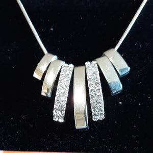 Mestige Silver Tone 18 inch chain with 7 silver tone charms, 2 with crystals  ---   item A020