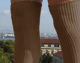 May include: A pair of brown ribbed knee-high socks. The socks are made of a soft, comfortable material and are perfect for everyday wear.