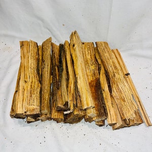 May include: A bundle of natural wood kindling sticks, perfect for starting a fire. The sticks are various shades of brown and have a rough, textured surface.