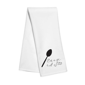 Puede incluir: Toalla de cocina blanca con una silueta negra de una cuchara y el texto "Cause A Stir" en cursiva negra.
