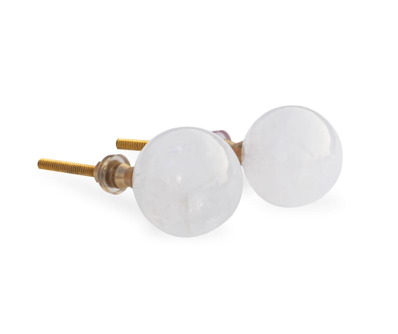 May include: Two white round cabinet knobs with gold metal screws. The knobs are made of clear glass with a cloudy white finish.