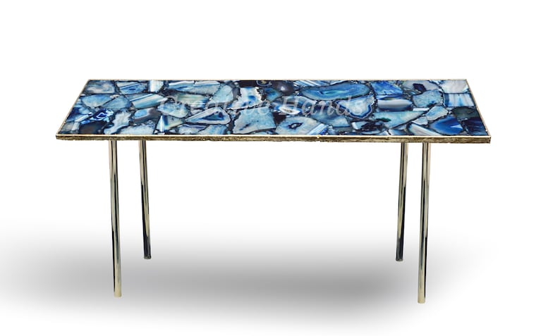 May include: A blue agate coffee table with a gold trim and chrome legs. The table top is made of natural agate stone and has a unique pattern.