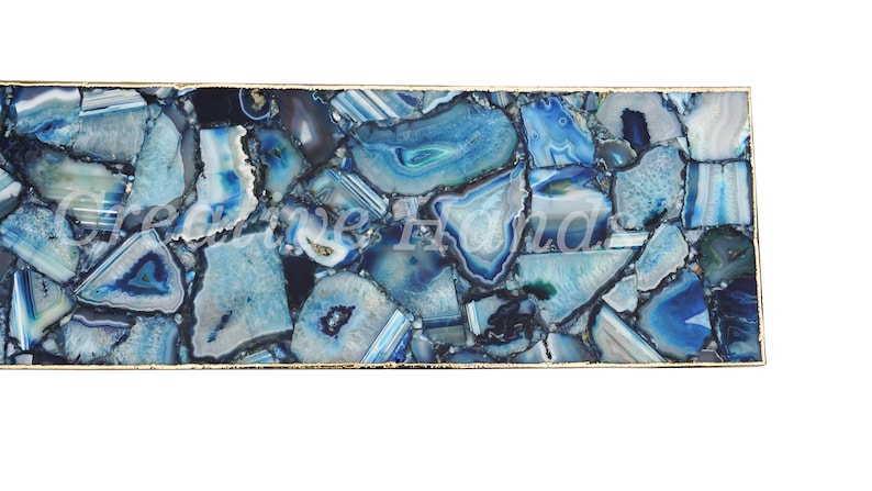 May include: A rectangular tray with a gold metal frame and a blue agate stone surface. The stone is cut into many small pieces and arranged in a mosaic pattern.