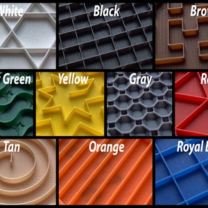 May include: A collection of 10 different colored silicone baking mats with various embossed patterns. The mats are labeled with their color: white, black, brown, forest green, yellow, gray, red, tan, orange, and royal blue.