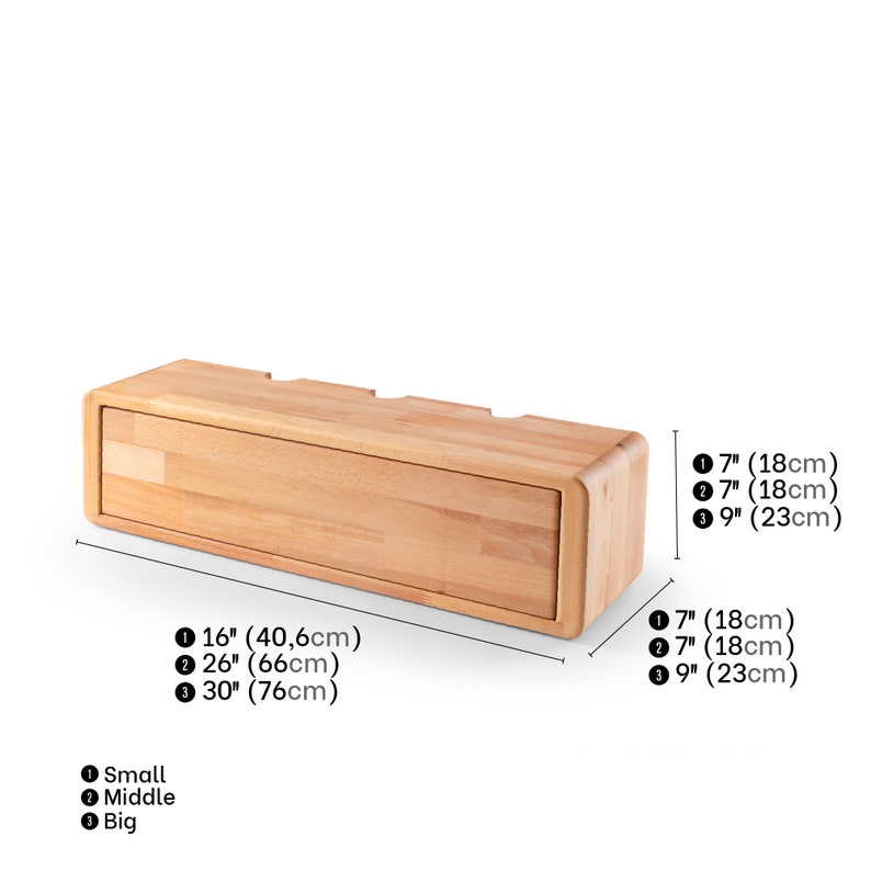 May include: A wooden wall-mounted shelf with three compartments. The shelf is 16 inches wide, 26 inches wide, or 30 inches wide. The compartments are 7 inches deep. The shelf is made of natural wood.