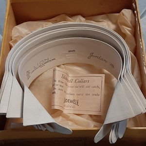 May include: A box of white Slidell Collars in a brown box with the text "Slidell Collars" and "Sidewell" on a label. The box also has the text "Lion Collar & Shirts, Inc." and "Jordan 14 1/2".