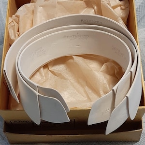 May include: A set of three white, stiff, collar inserts in a cardboard box. The inserts are labelled "PATENTED MARCH 1916".