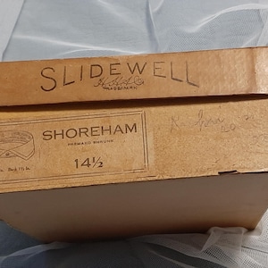 May include: A brown cardboard box with the text "Slidewell" and "Shoreham Premako shrunk" printed on it. The box is labelled with the size "14 1/2".