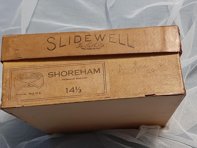 May include: A brown cardboard box with the text "Slidewell" and "Shoreham Premako shrunk" printed on it. The box is labelled with the size "14 1/2".
