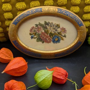 Vintage petit point needlepoint, Bouquet of pink and blue flowers- under glass, wood composite frame with gold/ blue hand painted detail.
