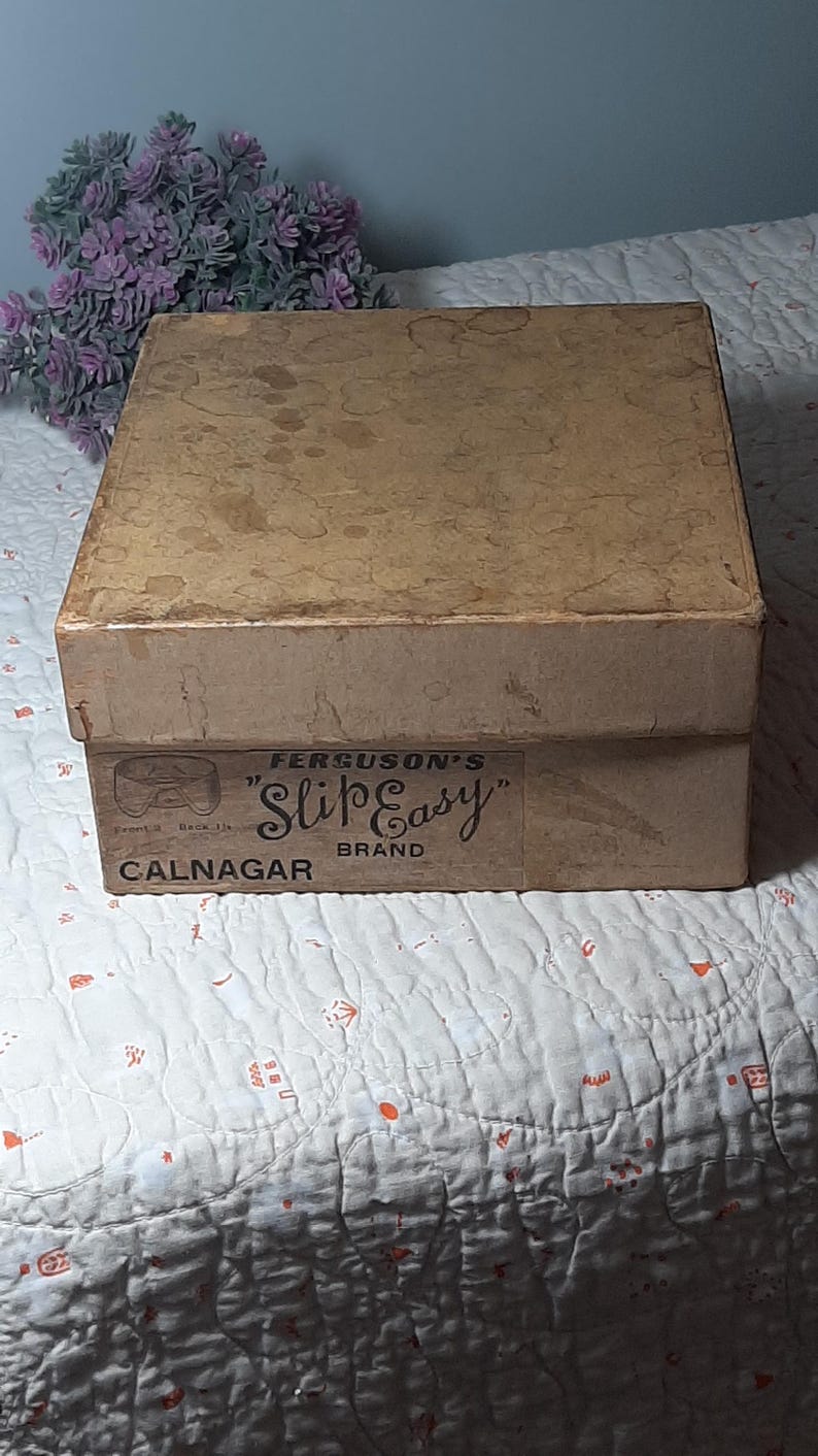 May include: A brown cardboard box with a label that reads "Ferguson's "Slip Easy" Brand Calnagar".