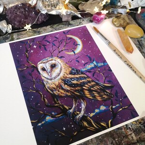 May include: A painting of a barn owl perched on a branch with a crescent moon in the background. The owl is depicted in shades of brown, gold, and white against a purple sky with gold stars. The painting is signed "Anna Collier" in the bottom right corner.