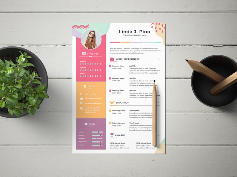 May include: A pink, yellow, and blue resume template with a photo of a woman in the upper left corner. The resume is for Linda J. Pino, a financial services sales agent. The resume includes sections for language skills, contact information, skills, work experience, education, and awards.