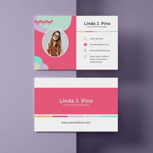 May include: A pink and white business card with a photo of a woman wearing glasses and holding a book. The text on the card reads "Linda J. Pino, Financial services sales agent, +1407-793-7283, youremai@gmail.com, www.yourwebsite.com, Lorem ipsum address amet, consectetuer adipiscing elit."