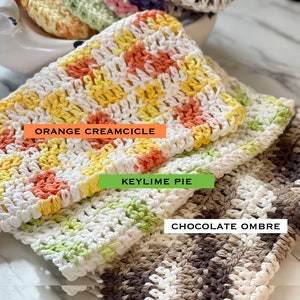 May include: Three rectangular crocheted washcloths with textured patterns. The top cloth is white, yellow, and orange with the text ORANGE CREAMCICLE. The middle cloth is white and light green with the text KEYLIME PIE. The bottom cloth is white and brown with the text CHOCOLATE OMBRE.