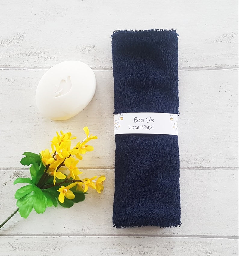 May include: A dark blue face cloth with a white label that reads "Eco Us Face Cloth".