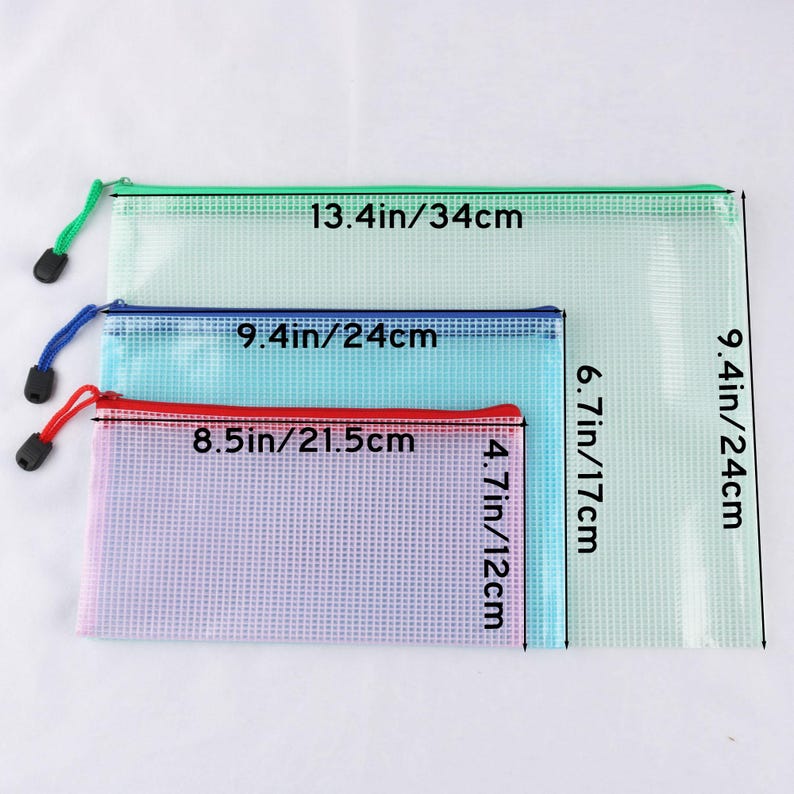 May include: Three zippered mesh pouches in varying sizes. The largest is light green, 13.4 inches (34 cm) wide and 9.4 inches (24 cm) tall. The medium pouch is blue, 9.4 inches (24 cm) wide and 6.7 inches (17 cm) tall. The smallest is pink, 8.5 inches (21.5 cm) wide and 4.7 inches (12 cm) tall.