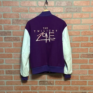 May include: Purple and white varsity jacket with "The Twilight Zone" embroidered on the back.