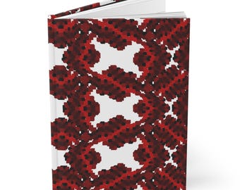 Könnte beinhalten: Ein Notizbuch mit einem roten und schwarzen Muster auf weißem Hintergrund. Das Muster ist ein sich wiederholendes Design aus kleinen Quadraten und Kreisen.
