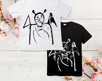 May include: Two t-shirts with a black and white graphic print of a creature with wings and antennas. The creature is wearing a robe and has a face with large eyes and a small mouth. One t-shirt is white with black print, and the other is black with white print.