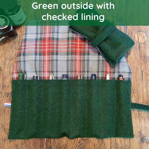 May include: A green felt pen roll with a plaid lining. The roll has eight slots for pens and a flap that closes with a strap.
