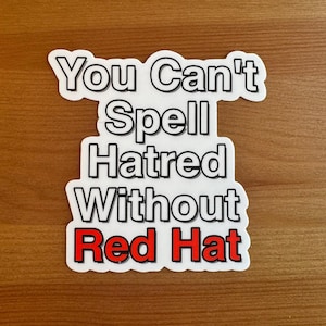 May include: White sticker with black text that reads "You Can't Spell Hatred Without Red Hat". The word "Red Hat" is in red.