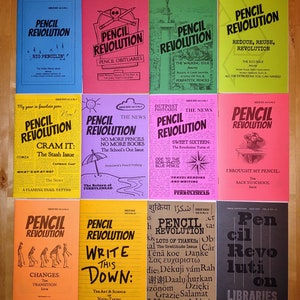 May include: A collection of 10 colourful magazine covers with the title "Pencil Revolution" printed in bold black letters. Each cover features a different illustration and text related to pencils and writing.