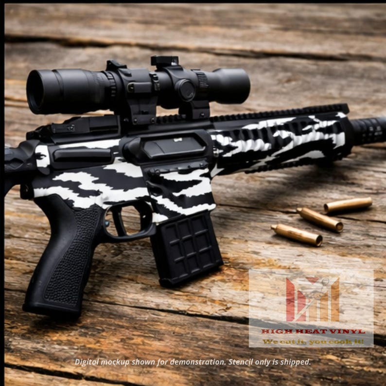 May include: A black and white rifle with a scope, featuring a zebra stripe pattern. The rifle is lying on a wooden surface with three bullets. The text "HIGH HEAT VINYL" and "We cut it, you cook it" is visible.