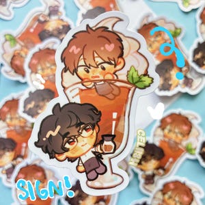 May include: A sticker featuring two cartoon characters with brown hair, one inside a drink and the other holding a small bottle. The drink is in a tall glass with whipped cream and a mint leaf. The word "SIGN!" is written in blue, and "CELISH" is written in green.