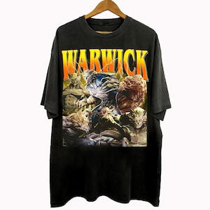 May include: Black t-shirt with the word "WARWICK" in orange and yellow block letters. The shirt features a graphic of several fantasy characters in shades of blue, brown, and gold.