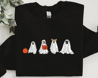 May include: Black sweatshirt featuring a design of four dogs dressed as ghosts for Halloween. One dog is holding a pumpkin bucket. The text "BLACK" is printed in white at the bottom of the image.