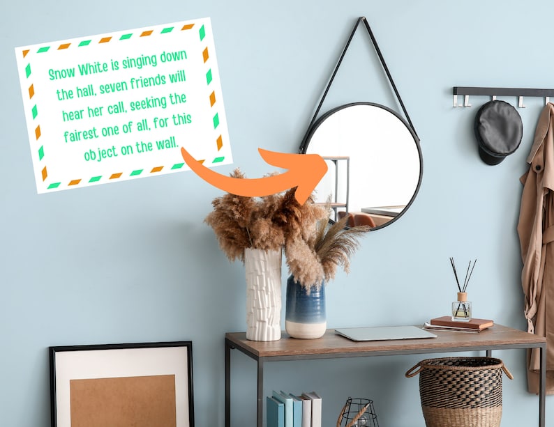 May include: A light blue wall with a round black mirror hanging on it. A decorative sign with the text "Snow White is singing down the hall, seven friends will hear her call, seeking the fairest one of all, for this object on the wall." is hanging on the wall. A brown wooden table with a laptop, a vase with dried flowers, and a basket is in front of the wall.